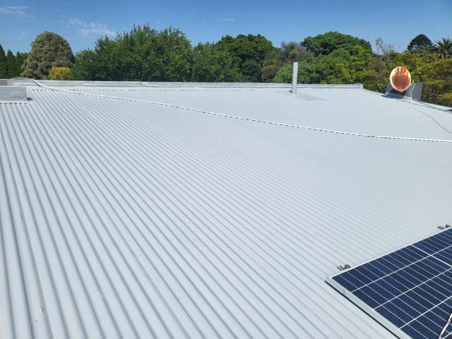 Freshly coated corrugated roof with solar panels, Linden