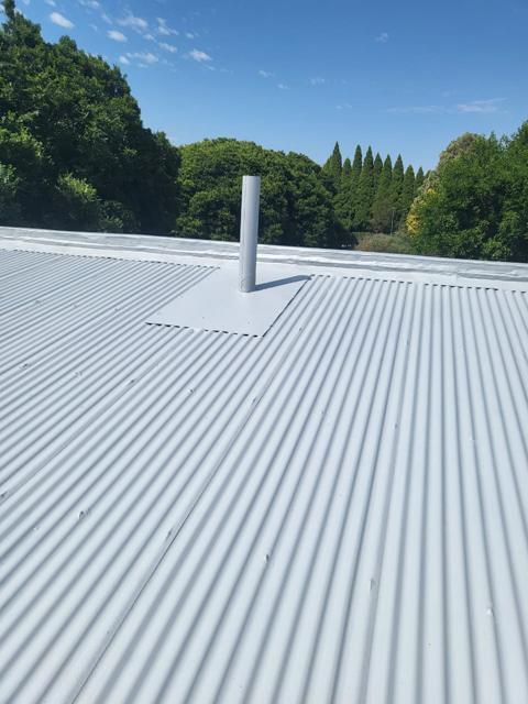 Sealed roof vent flashing on a coated roof