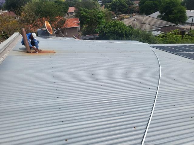 Roof before coating, with a crack running across the sheets